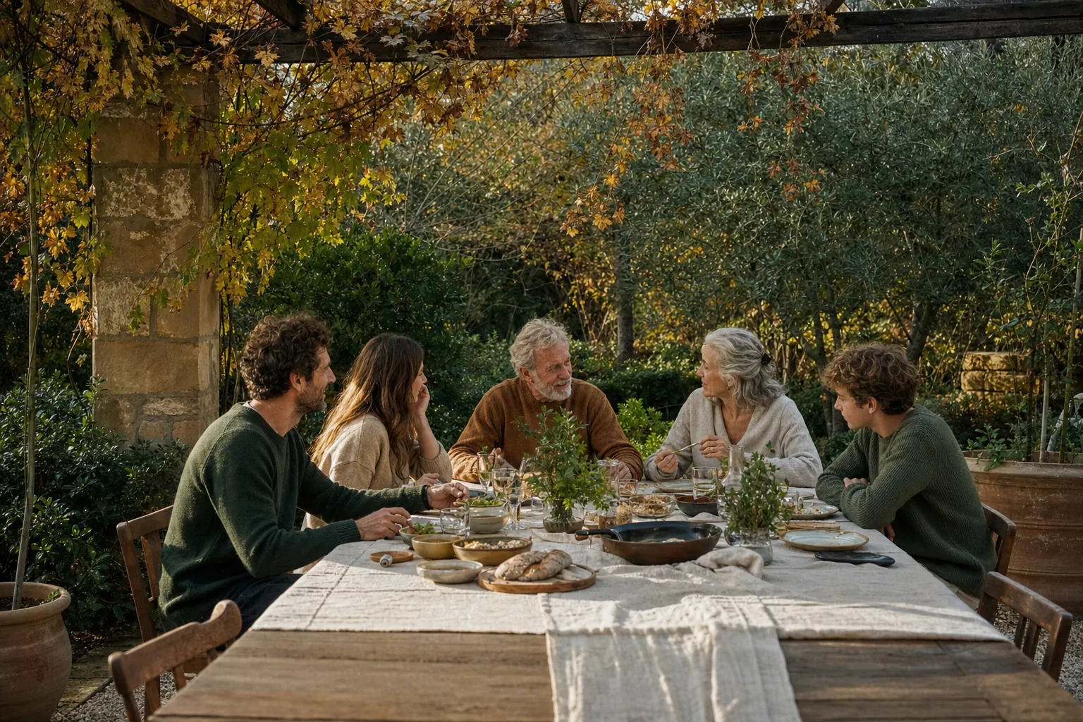 A multigenerational family enjoying an outdoor lunch together.